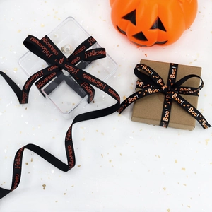 Detail of 10mm black Halloween ribbon with orange 'Boo!' and 'Halloween' text on gift box