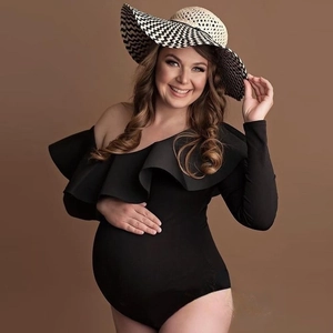 Elegant black maternity bodysuit with one-shoulder ruffle design for professional photography