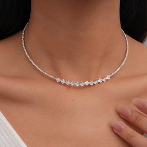 Close-up of elegant silver choker necklace with sparkling zircon crystals on model