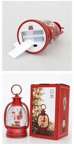 Detail of red Christmas snow globe lantern with battery compartment and packaging box