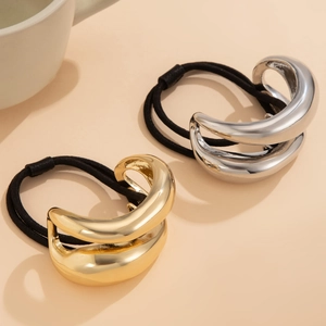 Detail view of double-layer curved elastic hair bands in gold and silver finishes