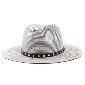 Detail of light gray straw fedora hat featuring a black leather band with silver metal studs