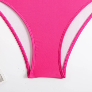 Detail of hot pink swimsuit featuring durable double-stitch seams and white mesh lining