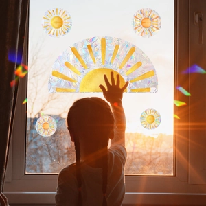 Rainbow sun static window cling showing colorful light refraction effect with child touching glass