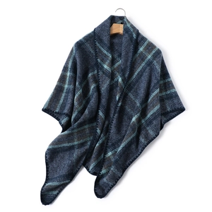 Detail of soft faux cashmere plaid scarf showing navy blue and brown check pattern texture