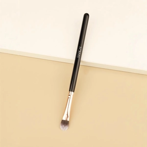 Tongue-shaped concealer and lip makeup brush with rose gold ferrule and black handle
