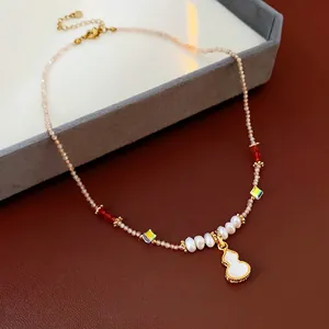 Luxe gourd pendant necklace with freshwater pearls and red beads in vintage gold style