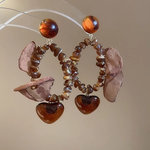 Detail view of vintage amber heart earrings with brown stone beads and mesh petals