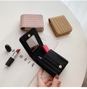 Mini leather lipstick pouch with mirror in black, pink, and khaki striped textures