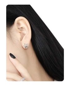 Close-up of S925 sterling silver bow knot earrings worn by a model for a refined look