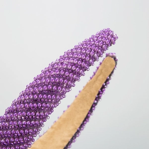 Elegant purple headband with diagonal rhinestones and pearls for a high skull top hairstyle