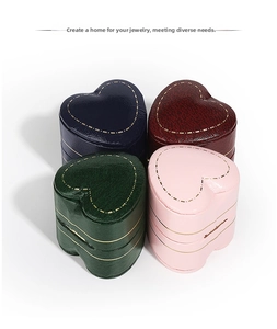 Detailed top view of heart-shaped faux leather jewelry boxes in four elegant colors