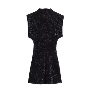 Close-up of black sequined sleeveless mini dress featuring a stylish high neckline