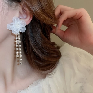 Elegant white floral tassel earrings with faux pearls and crystals on female model