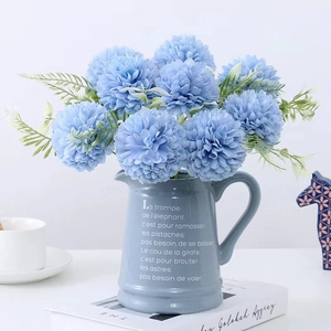Blue pompom chrysanthemum artificial flowers in a ceramic vase for home decor