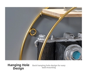 Detail showing the wall-mounting hole design of a round gold metal and wood storage shelf
