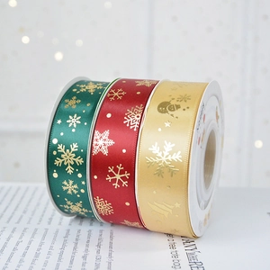 Christmas satin ribbons with gold snowflake patterns in red, green and gold colors