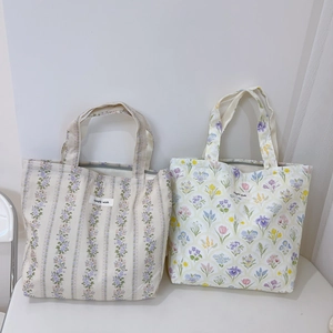 Detailed view of floral canvas tote bags featuring simple wish woven labels and zip closure