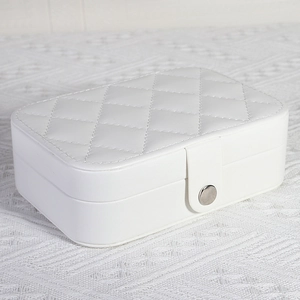 Portable white faux leather jewelry box with quilted pattern and metal snap closure