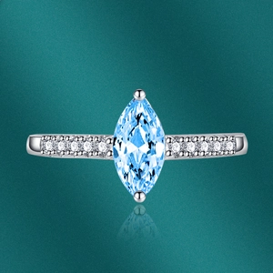 Macro detail of marquise cut aquamarine gemstone ring with micro-pave diamonds