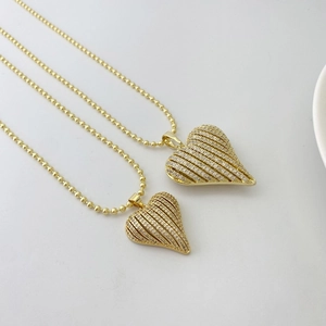 Golden heart pendant necklace with striped design and clear zircon stones on bead chain