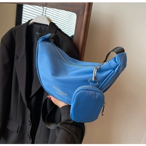 Dettaglio borsa a mezzaluna in nylon blu vivace con mini pochette e logo stampato
