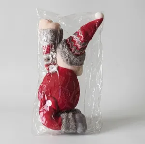 Christmas plush doll curtain buckle in packaging on gray floor for festive home decoration