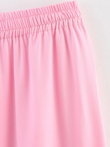 Detail of pink elastic waistband and twill fabric texture on casual loose trousers