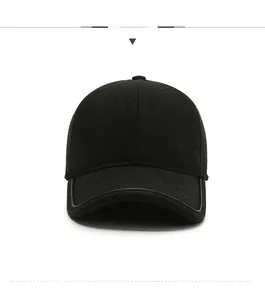 Detail view of a black wool baseball cap for men featuring a square silver metal logo