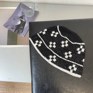 Detailed macro shot of a handmade crochet bucket hat with floral knit patterns