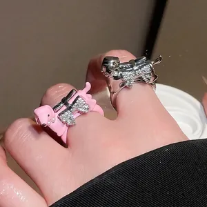 Cute puppy rings set with pink lacquer, silver finish, and sparkling zircon bow tie