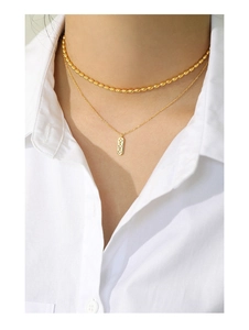 Double-layered gold S925 silver necklace with stars and zircons on white shirt