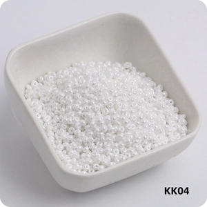 Detail of 3mm cream white glass seed beads in a ceramic bowl for DIY jewelry