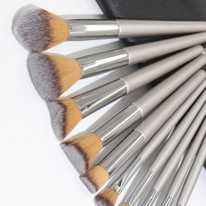 Champagne gold makeup brush set with silver handles arranged in a professional fan shape