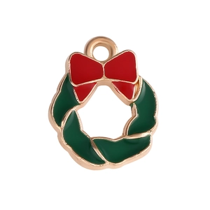 Christmas wreath pendant with green enamel leaves and red bow in golden alloy metal