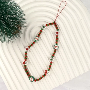 Detailed view of Christmas phone strap with Santa, candy cane, and red-green beads
