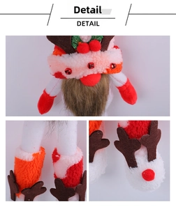 Detail showing plush Christmas gnome with elk horns and bells on a pink hat