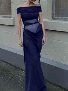 Close-up of elegant navy blue evening gown with sheer mesh waist and asymmetrical cut