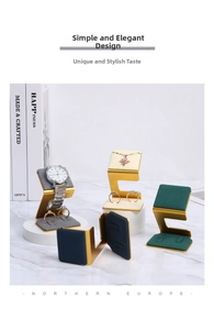 Detail of luxury gold metal jewelry display stands with colorful velvet inserts on marble