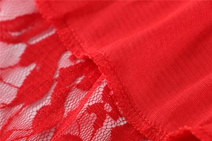 Detailed macro view of red lace stitching and knitted fabric on elegant short dress