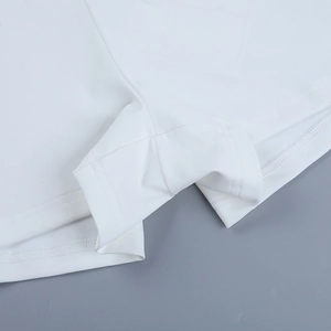 Detailed view of the double-needle flat seam stitching on white sports jumpsuit fabric