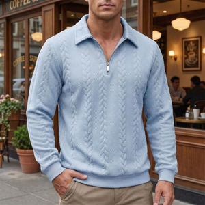 Close-up of light blue cable knit polo sweater with metal half-zip on outdoor male model