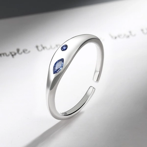 Detail view of 925 sterling silver open ring featuring blue sapphire zirconia gemstones