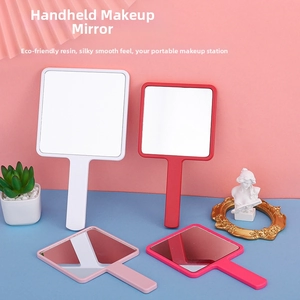 Various colored square hand mirrors with resin frames and long handles on a bright display