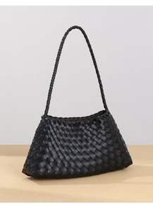 Close-up detail of the black hand-woven faux leather texture on the trapezoid shoulder bag