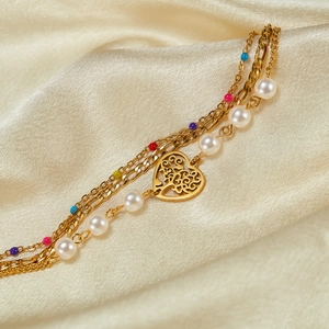 Multi-layer gold stainless steel bracelet with hollow heart charm and colorful pearls