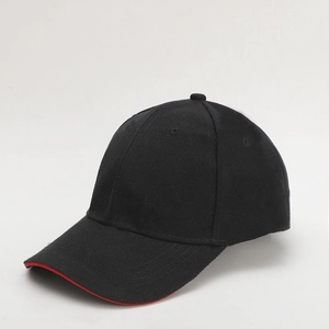 Detailed side view of black cotton baseball cap with red trim on the brim edge