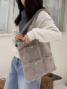 Fuzzy plush tote bag in light coffee brown with colorful button pockets for casual wear