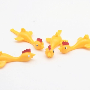 Macro shot of four yellow rubber slingshot chickens for stress relief and fun wall play