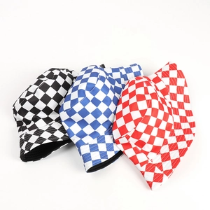 Detailed close-up of reversible checkered bucket hats in black, blue and red patterns